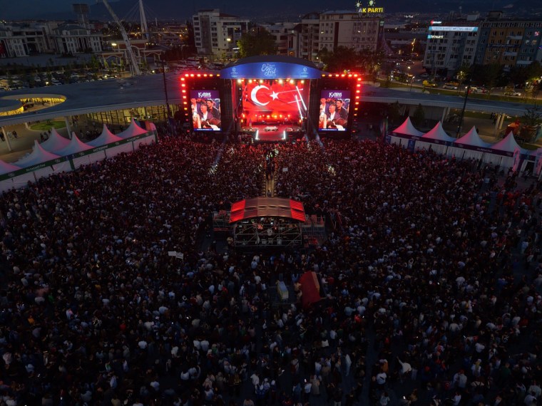 Yoğun kalabalığın yer aldığı gece konser alanı, sahnede Türk bayrağı ile kutlama yapılırken.